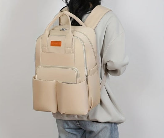 Beige backpack with a visible brand label on a white background