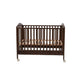 Wooden crib with wheels on a white background