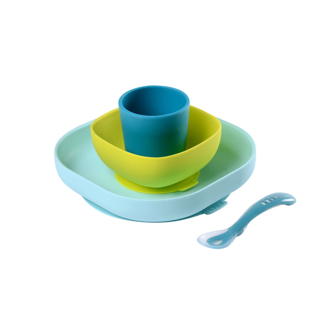 Children's dinner set with blue cup, green bowl, and light blue plate on a white background