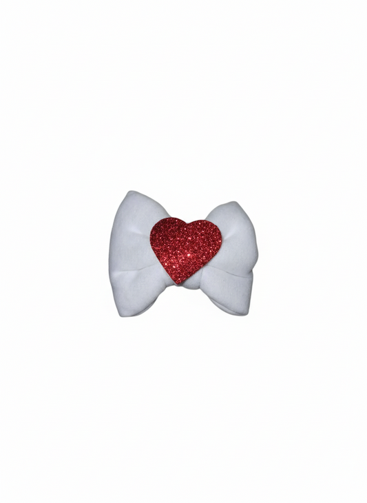 Baby girl white fabric bow headband with red sparkling glitter heart on black elastic band.