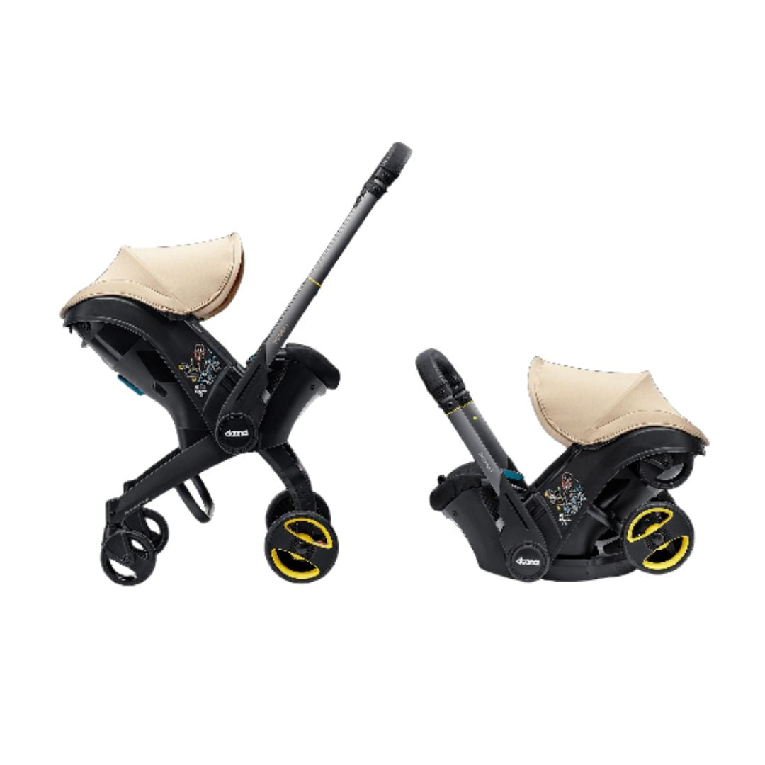 The Doona i 2-in-1 travel system in stroller mode with a faux-leather handlebar and adjustable headrest.