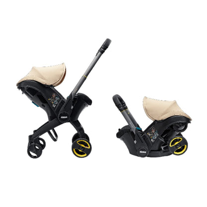 The Doona i 2-in-1 travel system in stroller mode with a faux-leather handlebar and adjustable headrest.