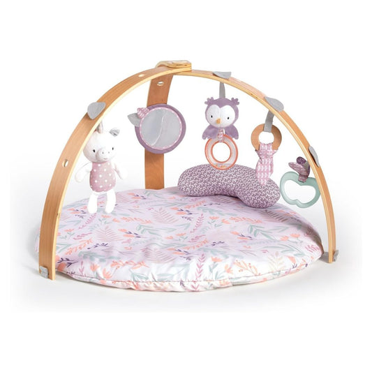 Pink Ingenuity Cozy Spot Activity Gym with wooden arch, reversible plush mat, and hanging natural toys.