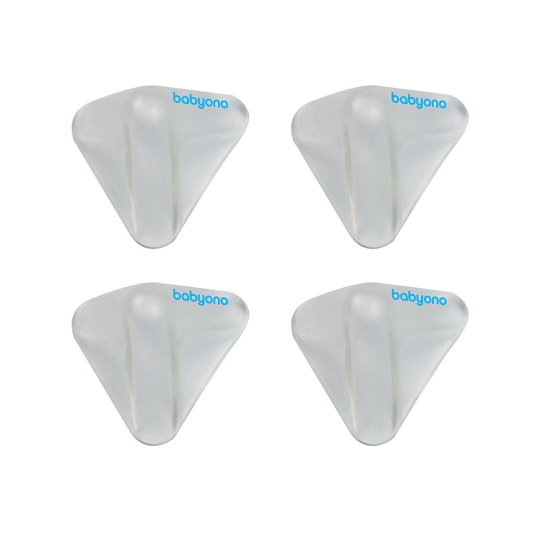 Pack of Babyono clear silicone corner protectors installed on the edge of a wooden table.