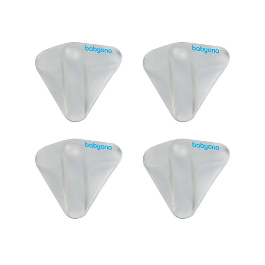 Pack of Babyono clear silicone corner protectors installed on the edge of a wooden table.