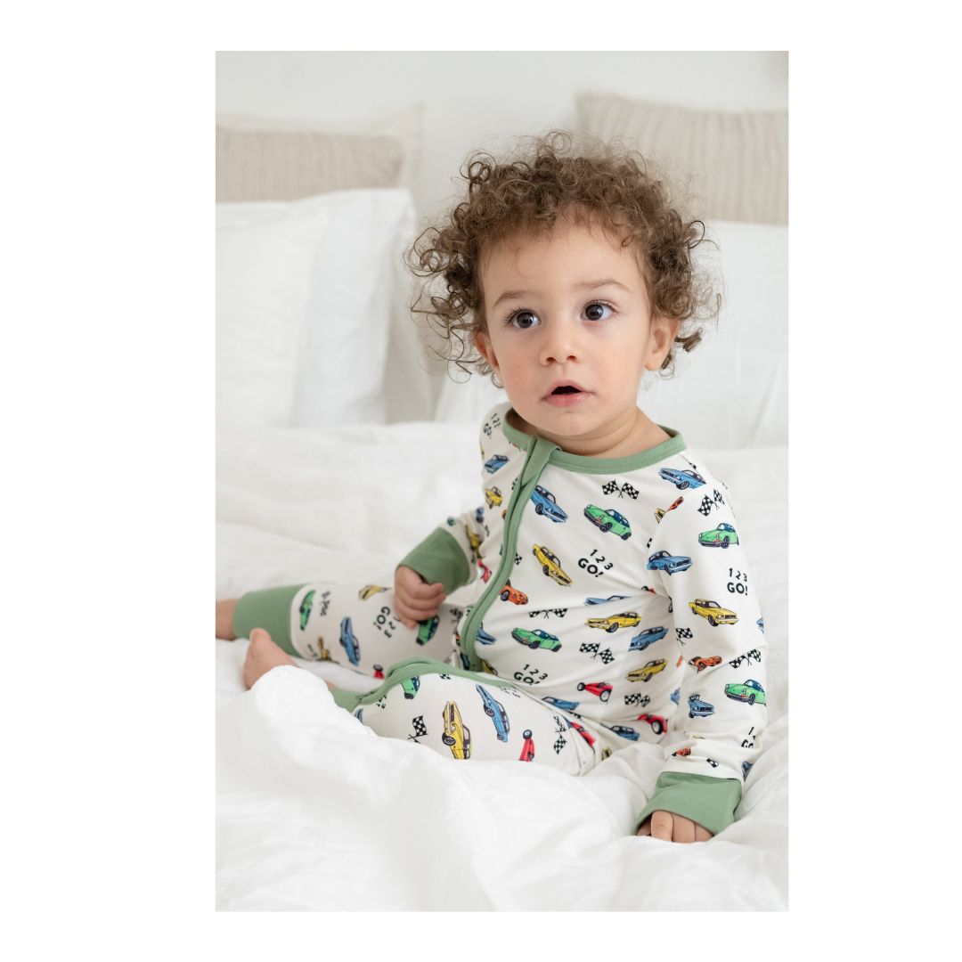 Cars" print bamboo viscose zippy onesie in size 6-9 months with double zipper and convertible foot cuffs.