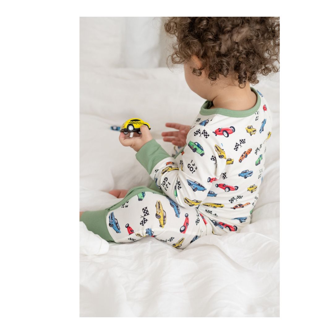 Cars" print bamboo baby zippy in 9-12 months size showing convertible foot cuffs for walkers and a double-sided zipper.