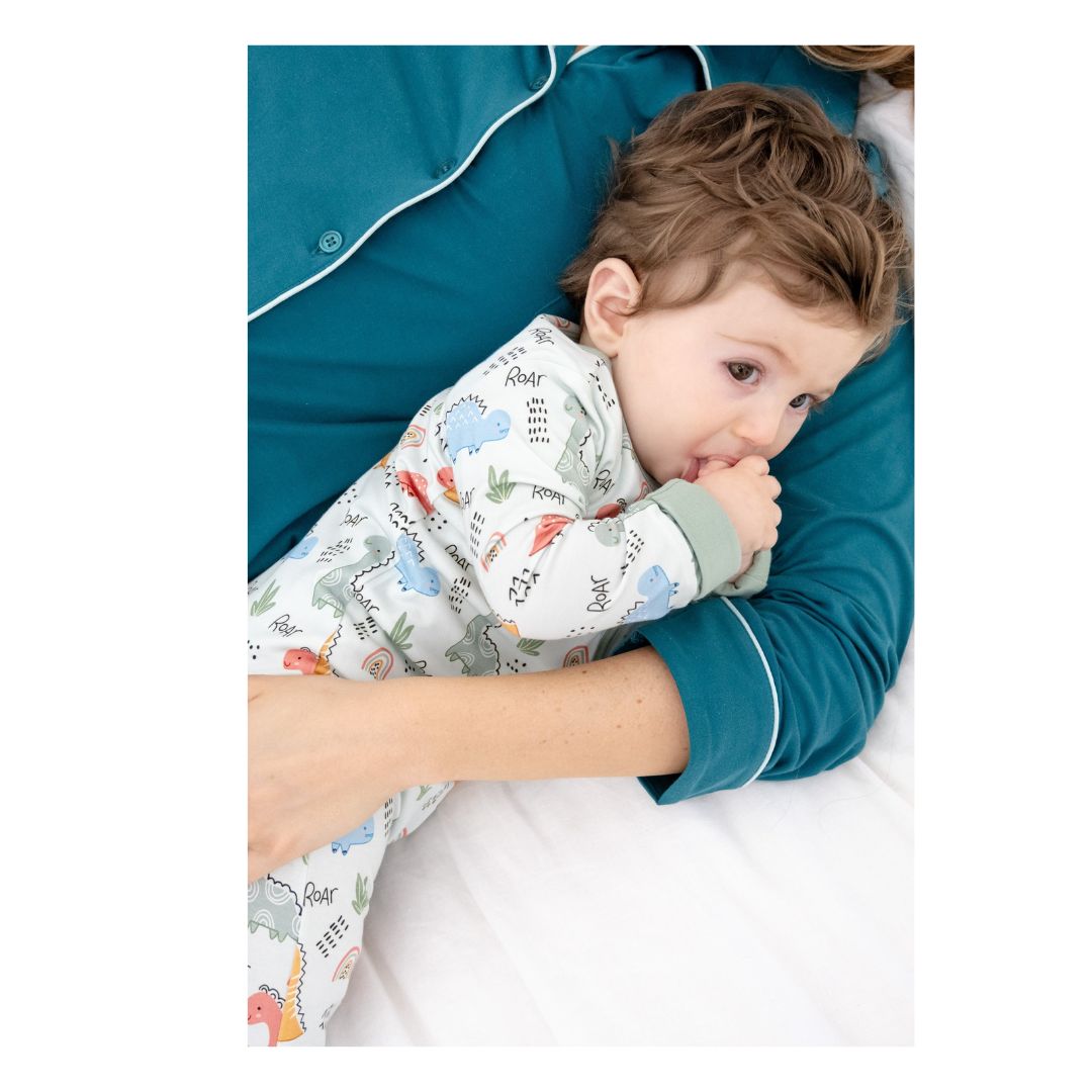 TeeJayz "Dino" print bamboo zippy in 18-24 months with foot cuffs folded up for playtime.