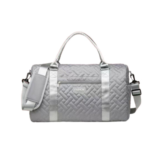 Gray quilted duffel bag with silver accents on a white background