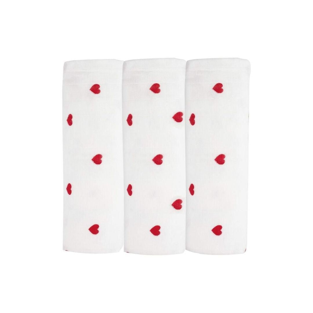 Three white socks with red heart patterns on a white background