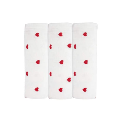Three white socks with red heart patterns on a white background